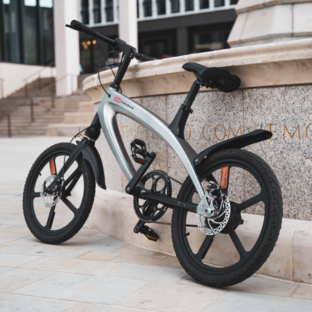 Cruzaa Carbon Black Electric Bike Resting On Wall